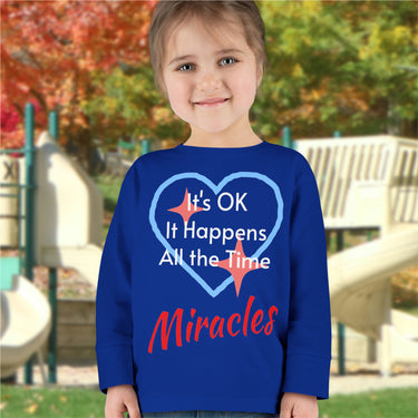 Rabbit Skins toddler long-sleeve t-shirt with “Miracles Happen” design and uplifting message, soft cotton, breathable and durable, Christian apparel for everyday wear and faith-filled gifting, todder girl in blue long-sleeve t-shirt